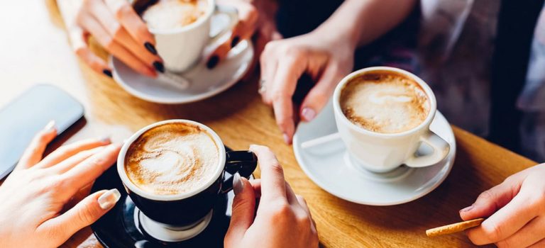 People sitting at a table enjoying coffee