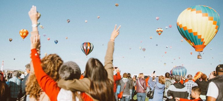Crowd watching hot air balloons ascending